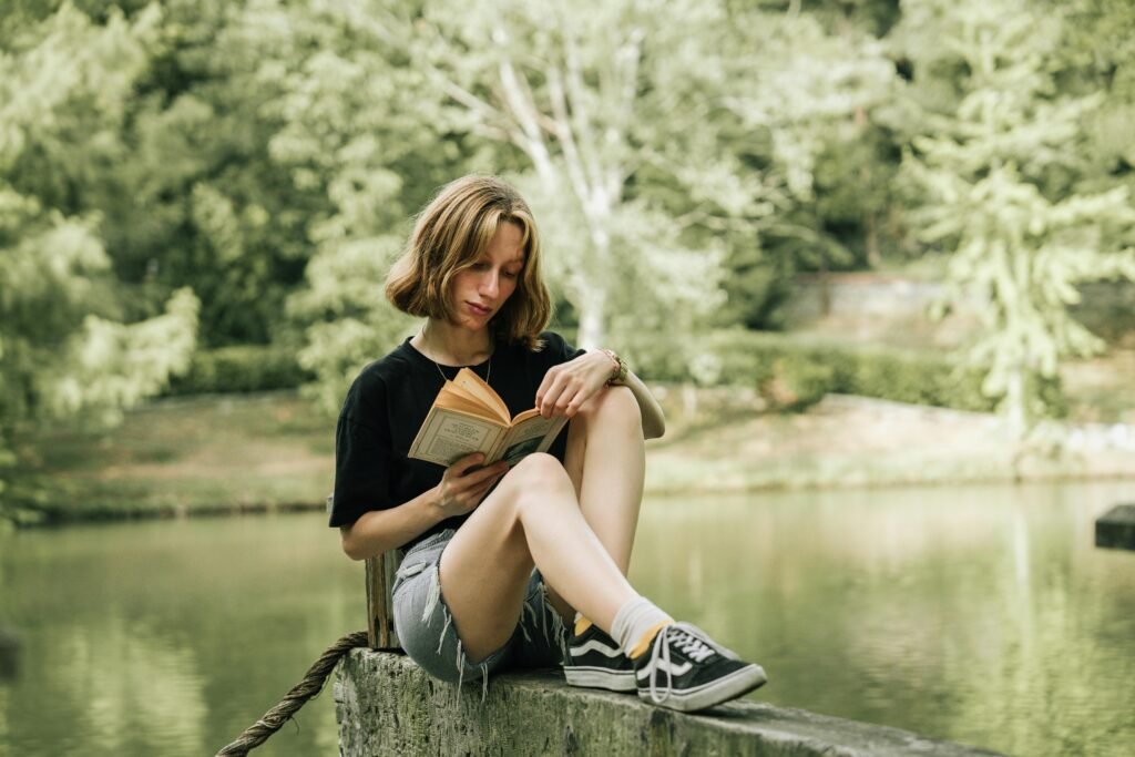 person journaling by a peaceful lake 