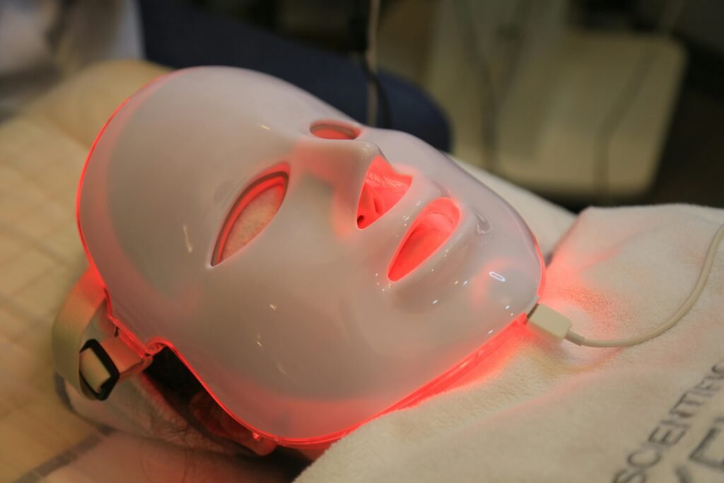  biohacking setup with a red light therapy face mask on a person